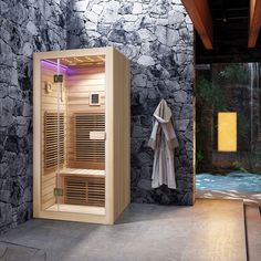 an indoor sauna is shown in front of a stone wall