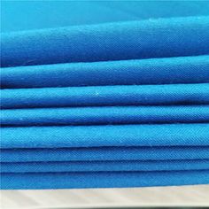 blue fabric is stacked on top of each other