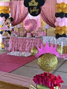 a minnie mouse birthday party with balloons and decorations