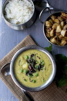 three bowls of food on a table with spoons and rice in them next to each other