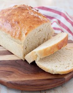 a loaf of bread sitting on top of a wooden cutting board