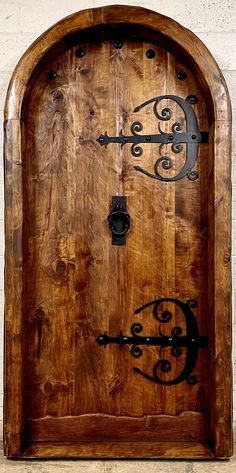 an old wooden door with wrought iron designs