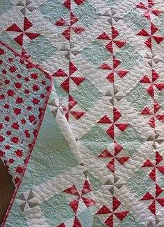 two quilts that are laying on top of each other, one is red and white