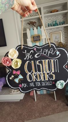 a person holding a sign that says we love custom order ask me for details