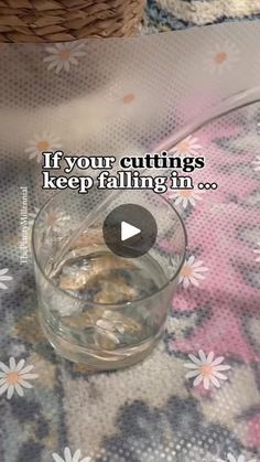 a glass bowl filled with coins sitting on top of a floral table cloth next to a basket