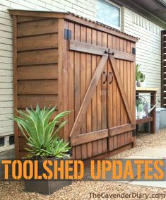 a wooden storage shed sitting on top of a patio next to a planter filled with flowers