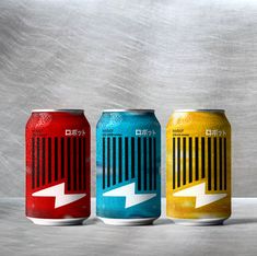 three cans of soda with an arrow painted on them