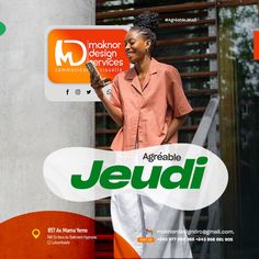 a woman holding a bottle of jeudii in front of a building with an ad on it