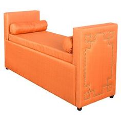 an orange couch with pillows on it