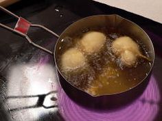 some food is cooking in a pot on top of the burner with a spatula