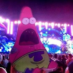 a pink spongebob character standing in front of a crowd