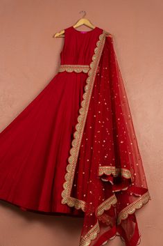 The Red Anarkali Set features a stunning red Anarkali adorned with intricate embroidery, paired with a matching dupatta. Perfect for festive celebrations, this vibrant ensemble blends traditional charm with contemporary style, making it ideal for weddings, festivals, and special occasions. Red Floor-length Sharara With Zari Work, Red Dola Silk Lehenga For Eid, Red Anarkali Set For Reception During Eid, Red Chandbali Lehenga For Eid, Unstitched Red Chandbali Choli, Red Anarkali Churidar For Wedding, Festive Anarkali Set With Resham Embroidery And Traditional Drape, Red Kundan Lehenga For Eid, Red Anarkali Set For Reception And Eid