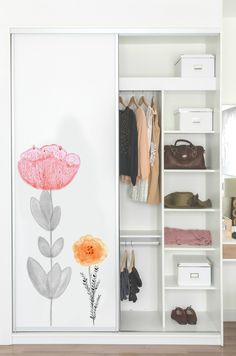 an open closet with shoes and handbags on the shelves, next to a painted flower