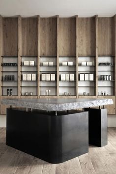 an iphone photo of a counter in a room with wooden cabinets and marble top on the floor