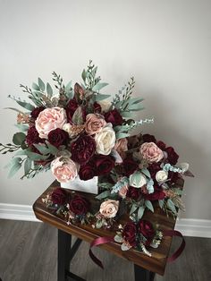 a bouquet of flowers sitting on top of a wooden table