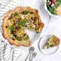 a table topped with pizza and salad on top of it