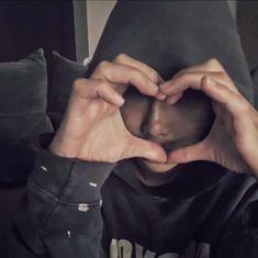 a person making a heart with their hands