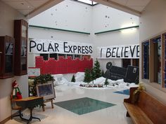 the inside of a building with snow on the ground and signs hanging from the ceiling