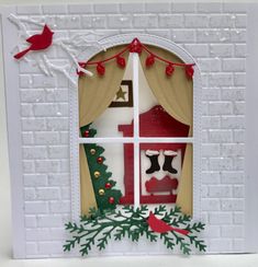 a christmas card with a red bird sitting on the window sill and a white brick wall