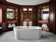 a large white bath tub sitting inside of a bathroom