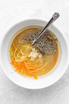 a white bowl filled with soup and carrots