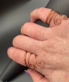 Wire Wrapped copper rings. Two styles/sizes. Perfect for any finger.  Items are handmade, please message with any questions. Handmade Bohemian Rose Gold Ring, Unique Handmade Adjustable Toe Rings, Handmade Rose Gold Bohemian Ring, Handmade Adjustable Unique Toe Rings, Unique Nickel Free Copper Rings, Handmade Rose Gold Toe Ring, Unique Copper Rings Nickel Free, Adjustable Gold Wire Wrapped Rings, Copper Wire Toe Rings