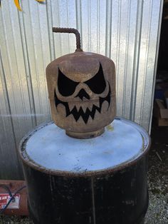 a halloween pumpkin sitting on top of a barrel