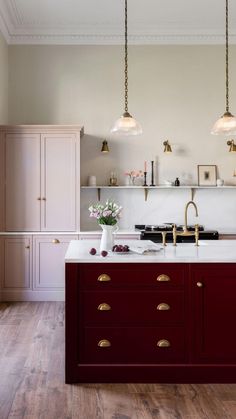 a kitchen with red cabinets and white countertops is featured in the magazine sale now on