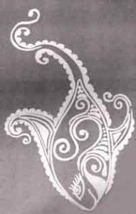 an intricately designed piece of cloth with white thread on the edges and in the shape of a paisley