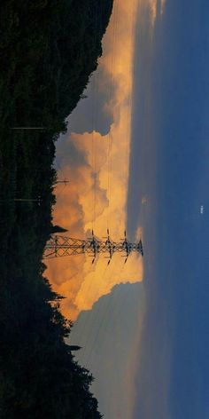 the sky is reflected in water with power lines