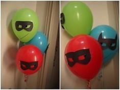 balloons with masks on them are hanging from the wall