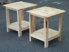 two wooden side tables sitting on top of a parking lot next to each other,