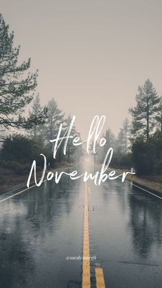 a wet road with the words life is november written in white on it's side