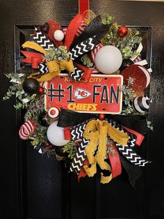 the front door wreath is decorated with football decorations