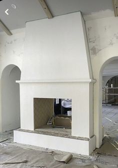 an unfinished room with a fire place in the middle