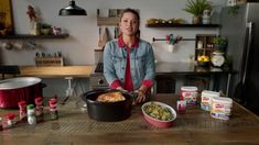 a woman standing in front of a table filled with food