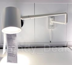 a lamp that is sitting on top of a counter next to a paper with a receipt under it