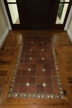 an entryway with a door and tile flooring on the side walk in front of it