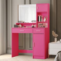 a pink vanity with mirror and drawers in a room next to a bed or desk