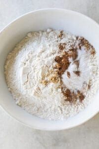 a white bowl filled with flour on top of a table