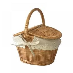 a wicker basket with white lace trimmings and a bow on the handle