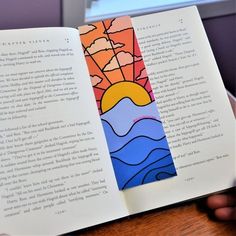 an open book with the pages cut out to look like it is on top of a table