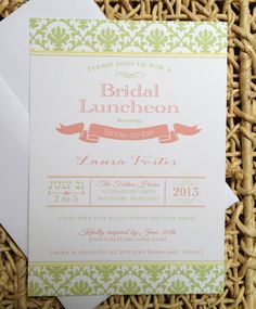 the wedding stationery is displayed on top of a wicker basket with an envelope