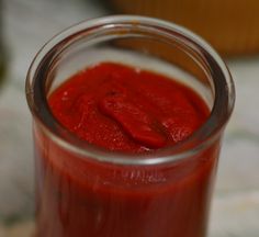 a jar filled with ketchup sitting on top of a counter