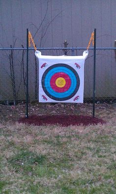 an archery target is hanging on a fence