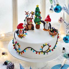 a white cake with christmas decorations on it