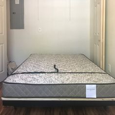 an empty mattress is in the corner of a room