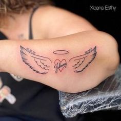 a woman's arm with an angel tattoo on the back of her left arm