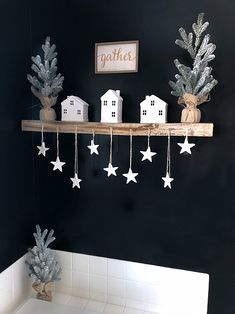 a bathroom decorated in black and white with stars hanging from the ceiling, along with other decorations