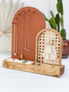 a wooden stand with jewelry on it